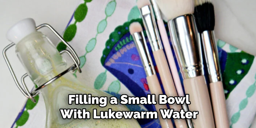 Filling a Small Bowl With Lukewarm Water