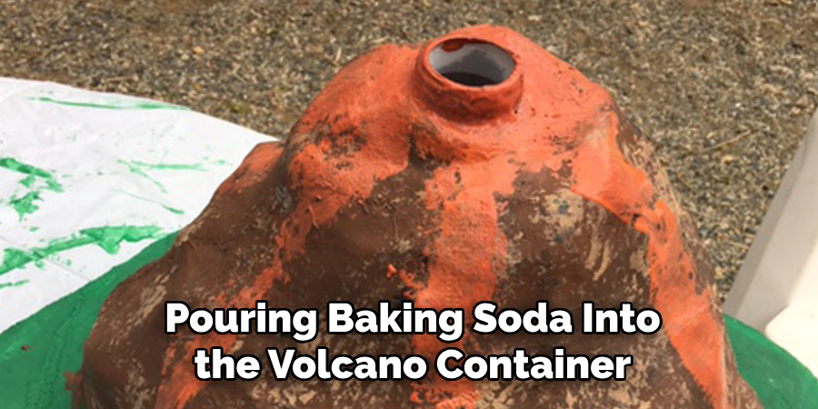 Pouring Baking Soda Into the Volcano Container