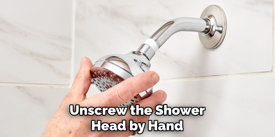 Unscrew the Shower
Head by Hand